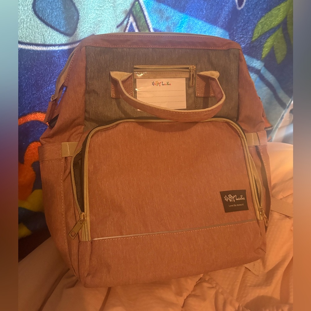 Diaper bag with built-in changing station and built-in bottle holders